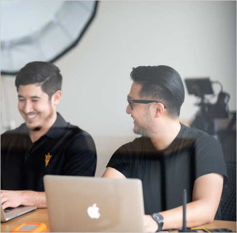 two students working on their laptops